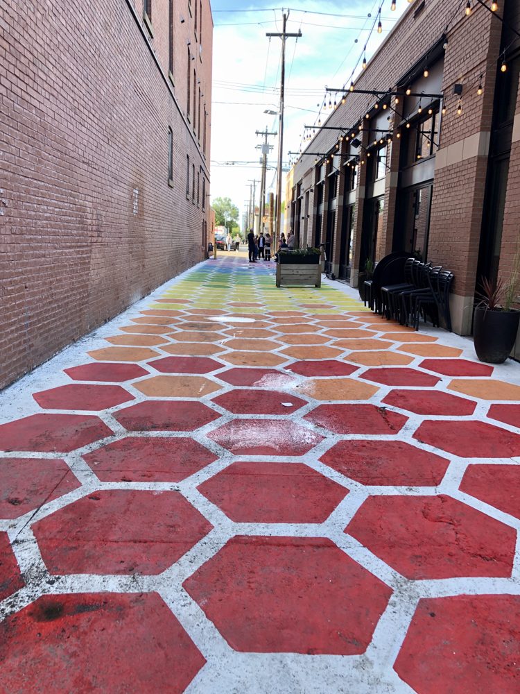 Rainbow-painted hexagon pavement in a downtown Edmonton alley